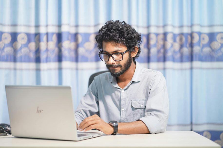 Remote customer support agent managing live chat on laptop.