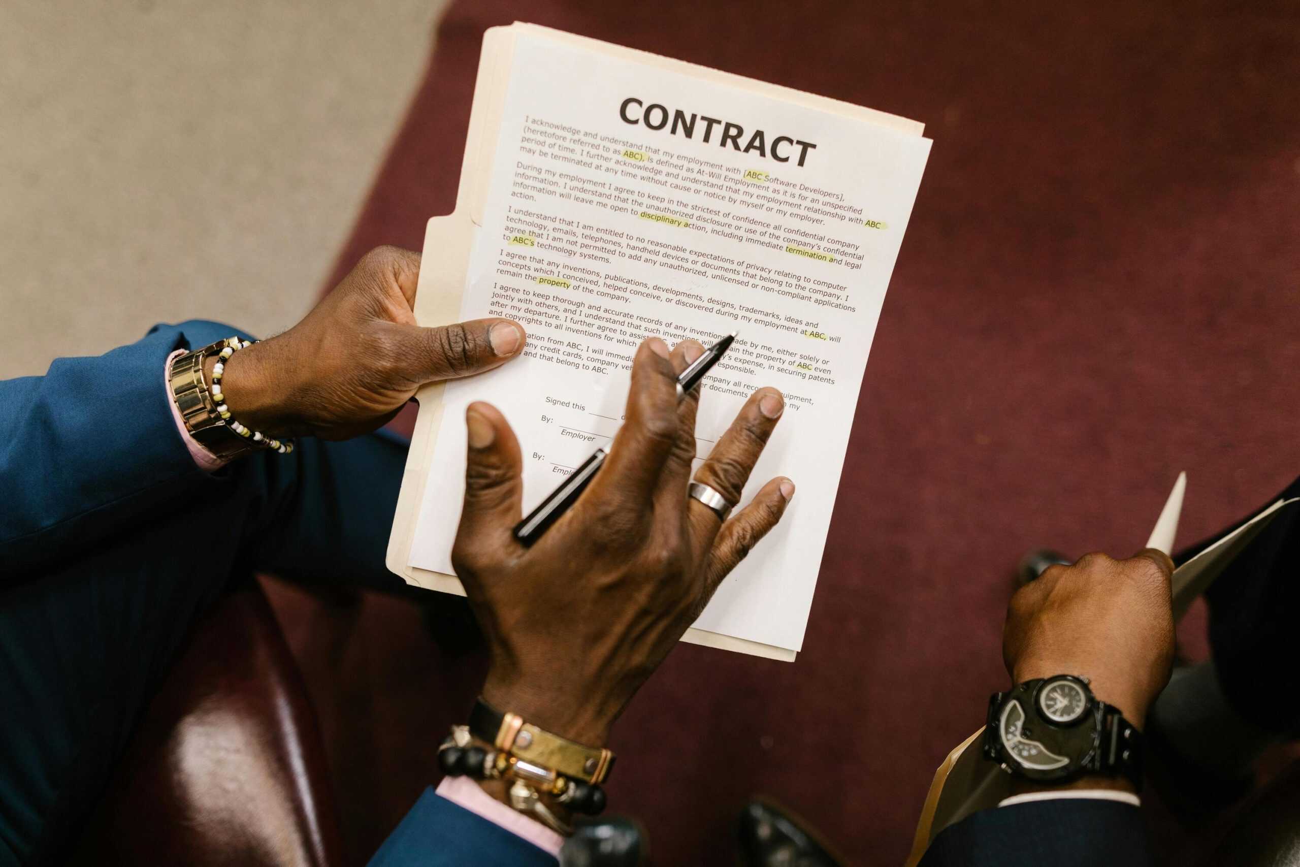 Close-up of hands reviewing a contract during a live chat monitoring session for customer engagement and quality assurance.