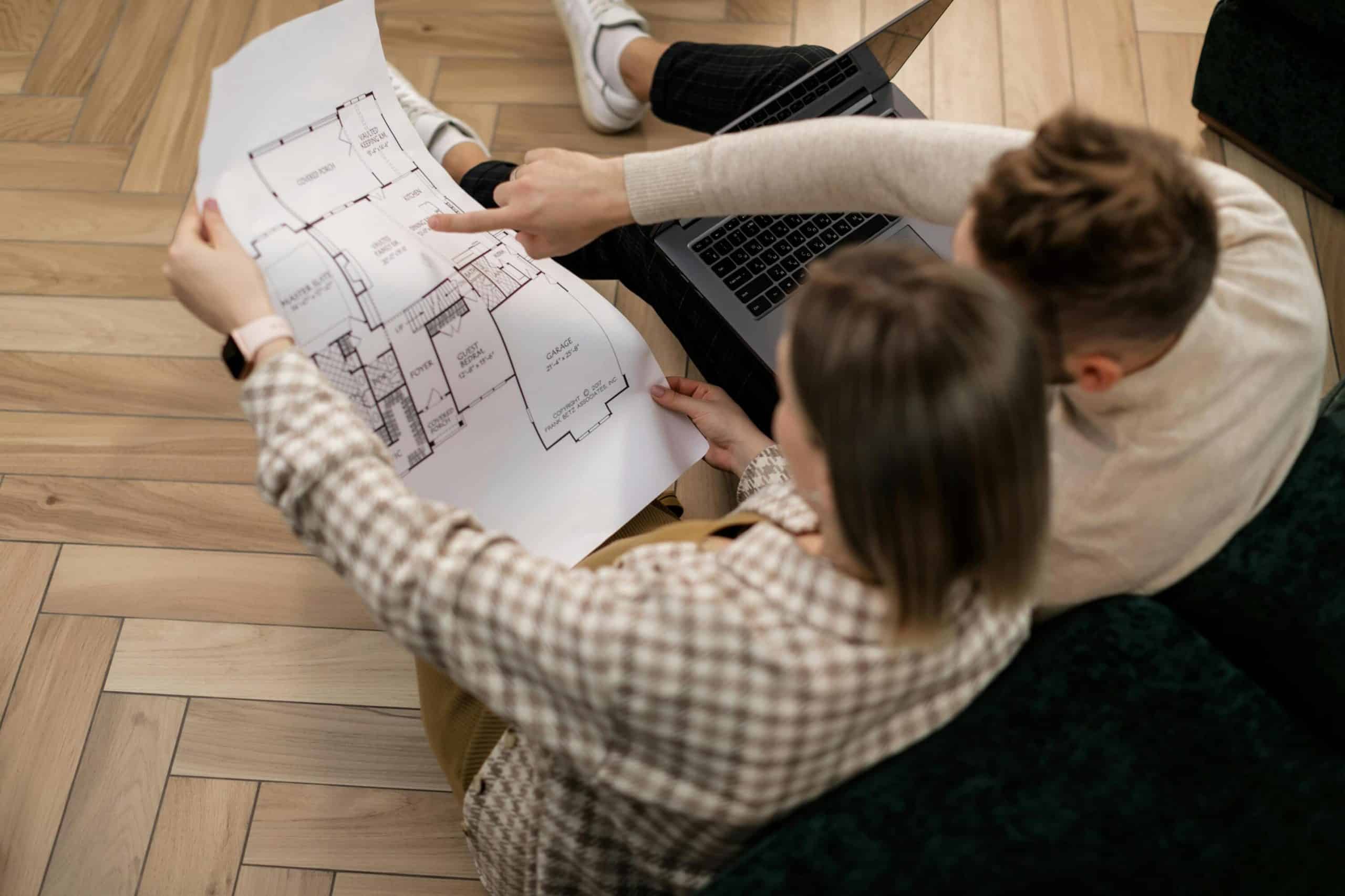 Detailed architectural blueprint discussion with team at home or office.