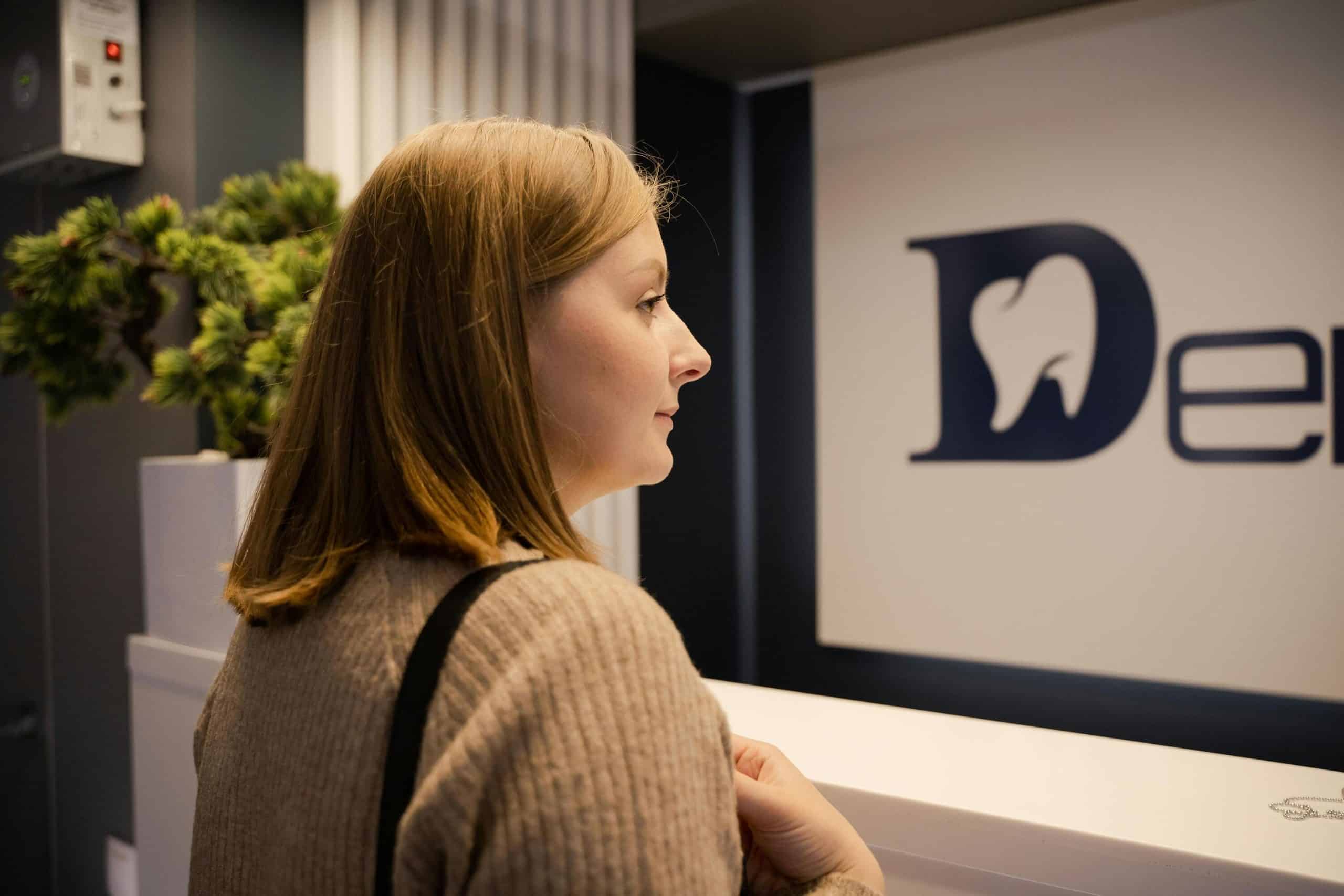 Woman using live chat monitoring system at dental office.