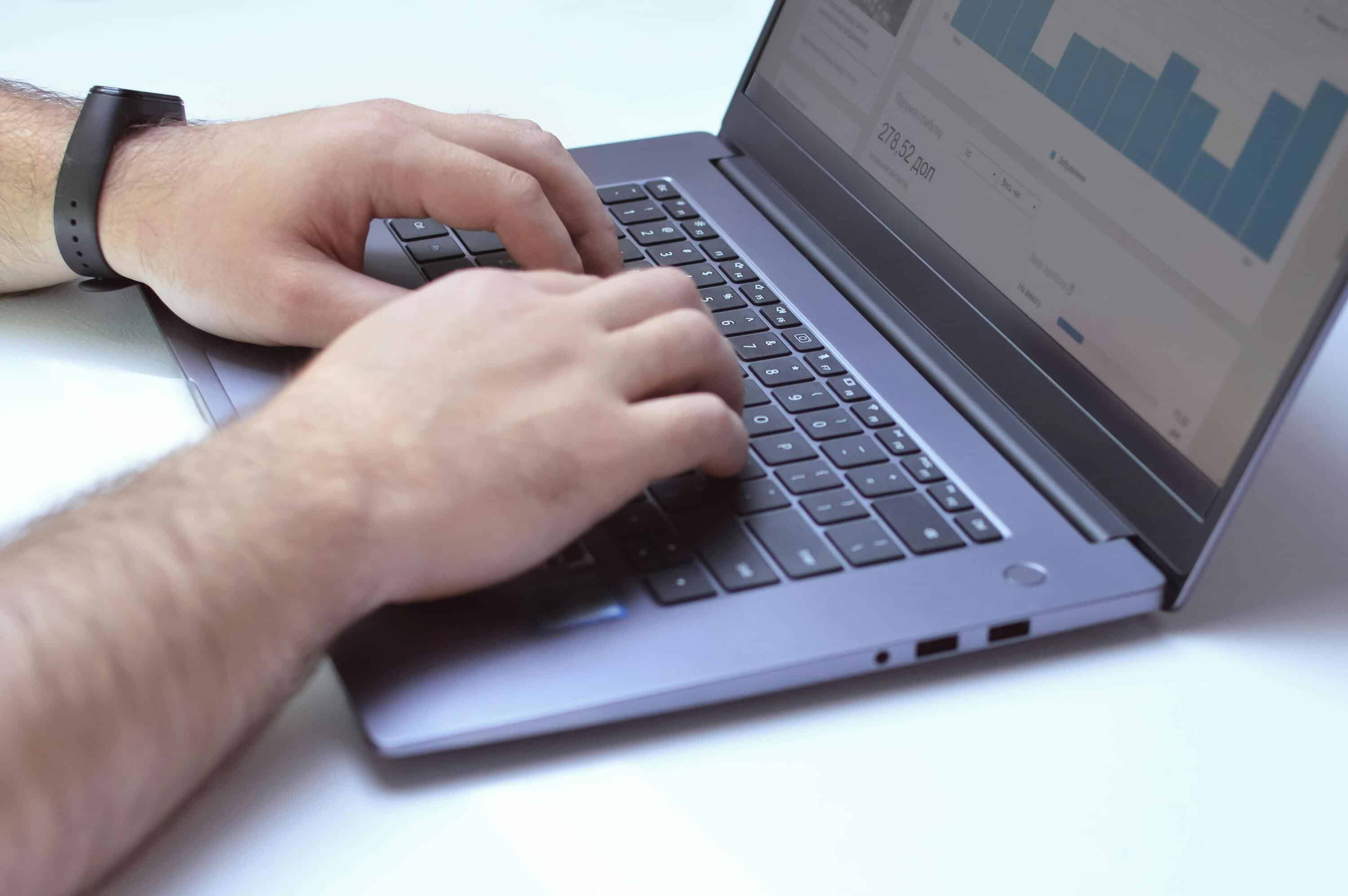 Person monitoring live chat analytics on a laptop screen for customer service insights.