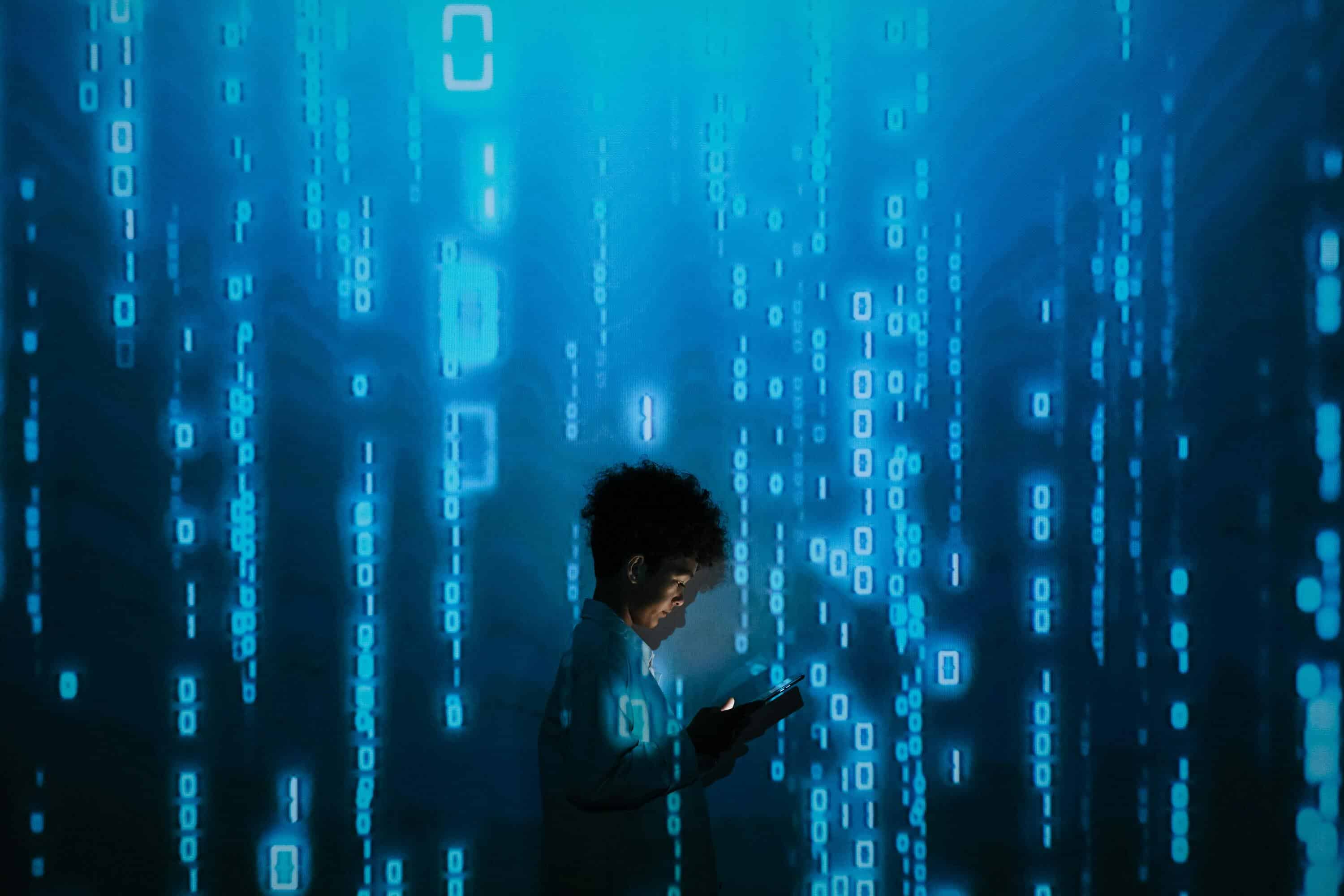 Woman using live chat monitoring software on tablet with digital data background.