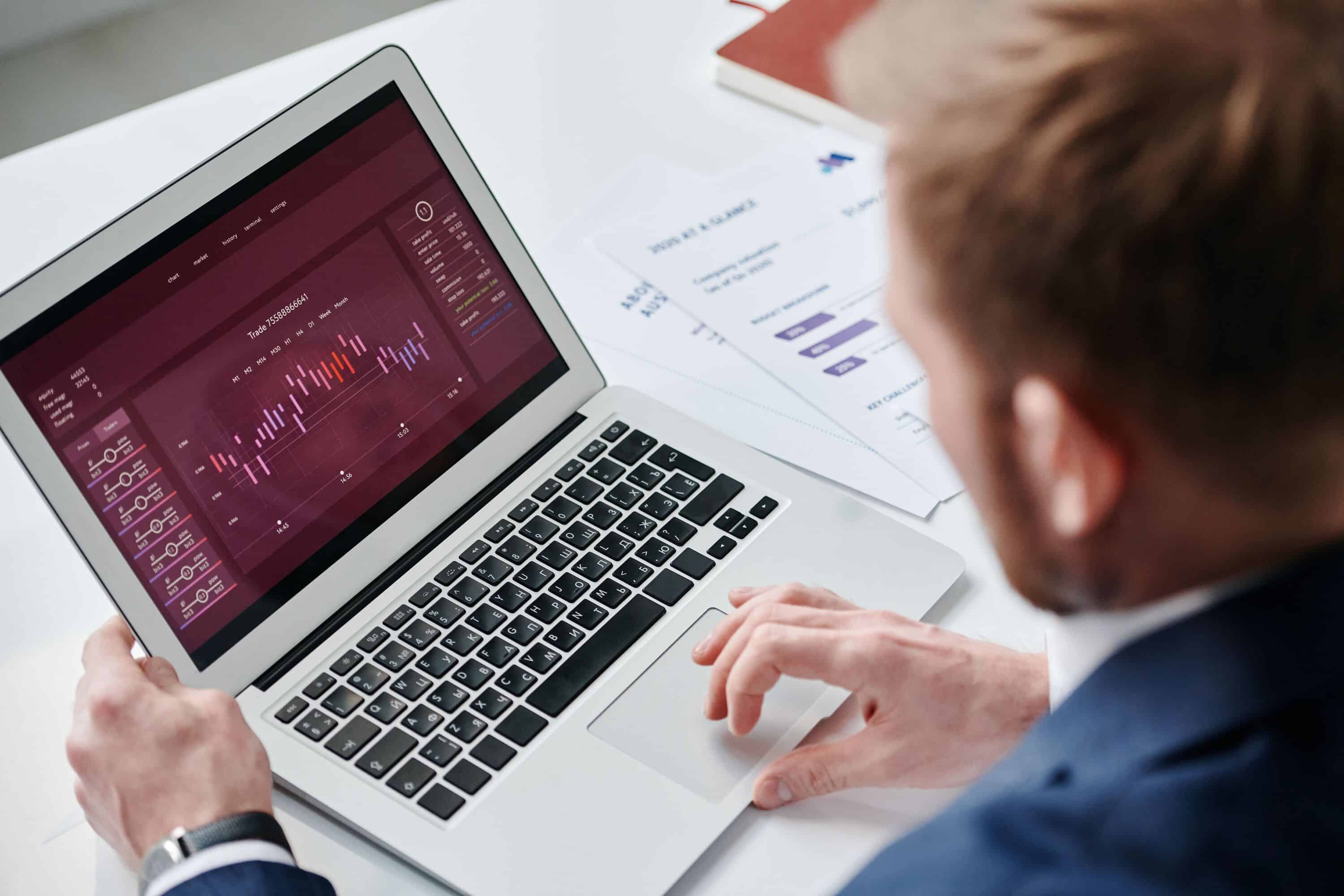 Person analyzing live chat data on a laptop for customer service insights.