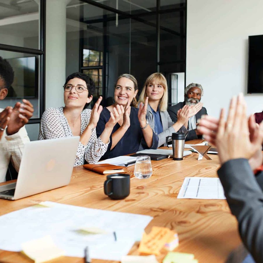 Happy-work-team-cheering-and-celebrating-at-meeting-team-collaboration